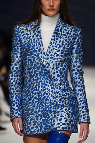 MİLAN, İTALYA - 24 Şubat 2022 'de Milano Moda Haftası / Kış 2023' te İtalya 'nın Milano kentinde düzenlenen Genny defilesinde bir model podyumda yürüyor..