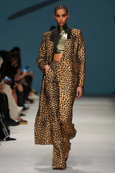 MİLAN, İTALYA - 24 Şubat 2022 'de Milano Moda Haftası / Kış 2023' te İtalya 'nın Milano kentinde düzenlenen Genny defilesinde bir model podyumda yürüyor..