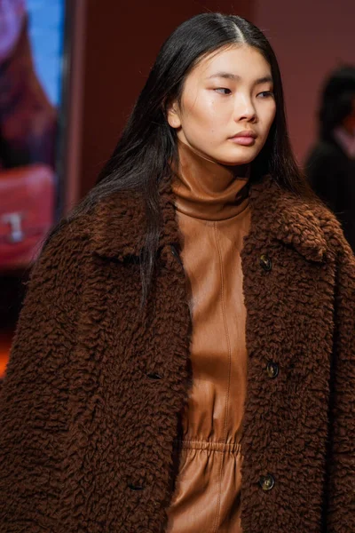 MİLAN, İTALYA - 25 Şubat 2022 'de Milan Moda Haftası / Kış 2023' te İtalya 'nın Milano kentinde düzenlenen Tod defilesinde mankenler podyum finalinde yürür..