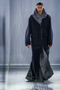 MILAN, ITALY - 26 Şubat 2022 'de Milano Moda Haftası / Kış 2023' te İtalya 'nın Milano kentinde düzenlenen Trussardi defilesinde bir model podyumda yürüyor..