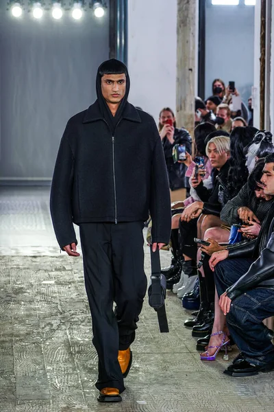 MILAN, ITALY - 26 Şubat 2022 'de Milano Moda Haftası / Kış 2023' te İtalya 'nın Milano kentinde düzenlenen Trussardi defilesinde bir model podyumda yürüyor..