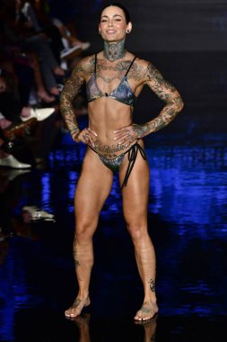 MIAMI BEACH, FLORIDA - 09 Temmuz 2021 'de Miami Beach, Florida' da düzenlenen Miami Yüzme Haftası sırasında Indigo Wild Swim Show 'da bir model podyumda yürüyor..