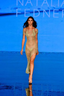 MIAMI BEACH, FLORIDA - JULY 08: A model walks the runway during the Natalia Fedner Show at Miami Swim Week Powered By Art Hearts Fashion at Faena Forum on July 08, 2021 in Miami Beach, Florida. clipart