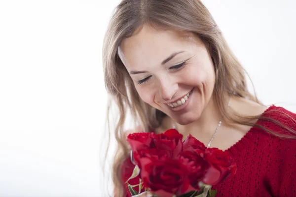 Woman in red sweater holding a rose — Stock Photo, Image