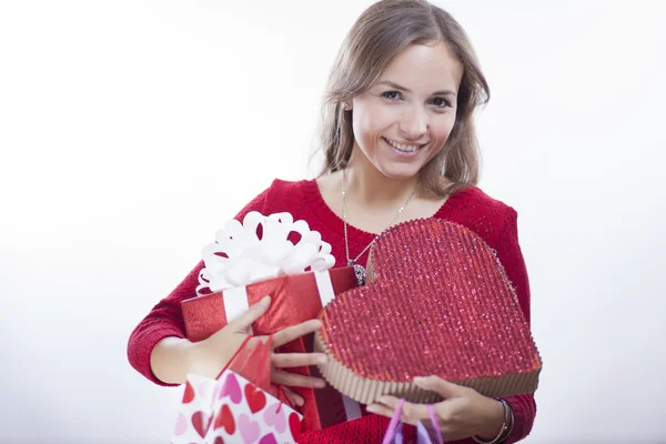 Young woman holding heart shaped gift — Stock Photo, Image