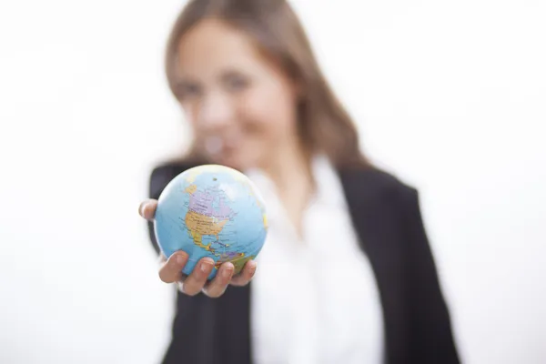 Business woman holding an earth model isolated on white background — Stock Photo, Image