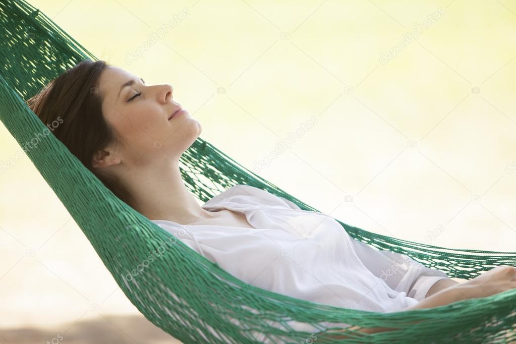 Young girl sleeping in a hammock