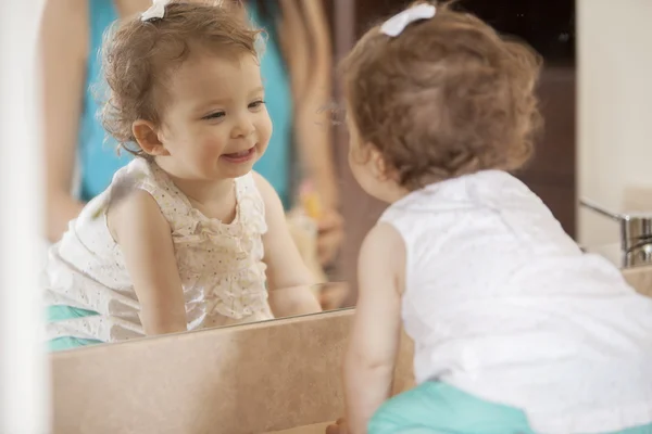 Cute baby looking into mirror — Stock Photo, Image