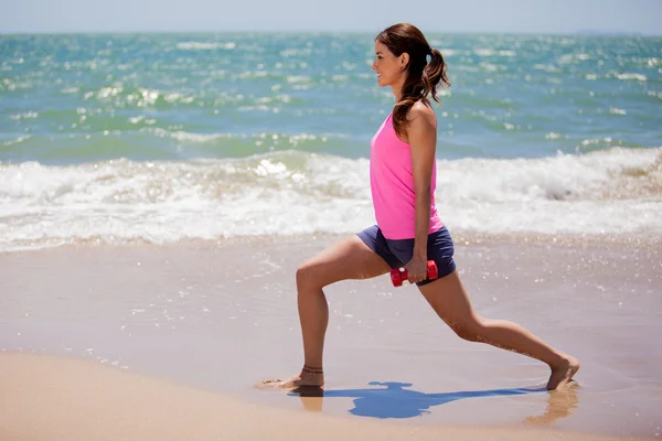 Young girl doing exercises with dumbells — Stock Photo, Image