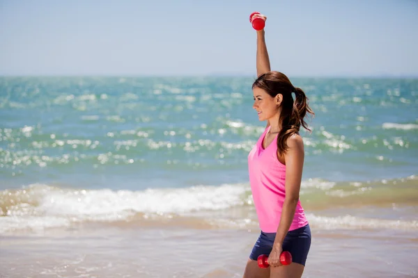 Young girl doing exercises with dumbells — Stock Photo, Image