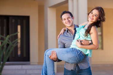 Newlyweds near their new home clipart