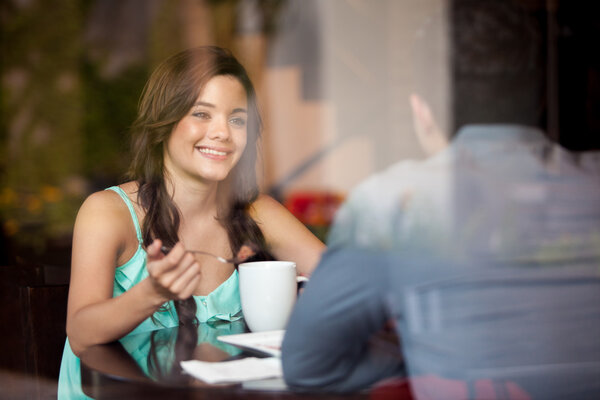 Latin woman eating cake with her date