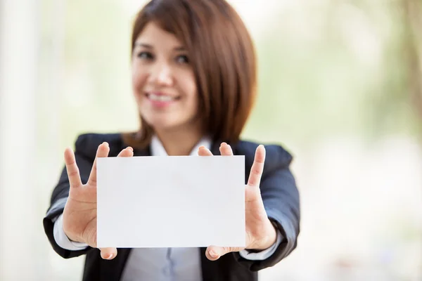 Young business woman showing a business card — Stock Photo, Image