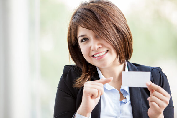 Young business woman showing a business card