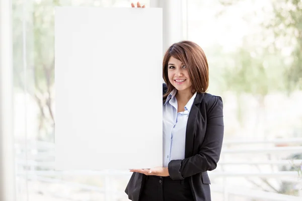 Attractive business woman holding white board — Stock Photo, Image