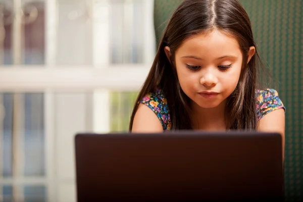 Happy little girl with laptop — Stock Photo, Image