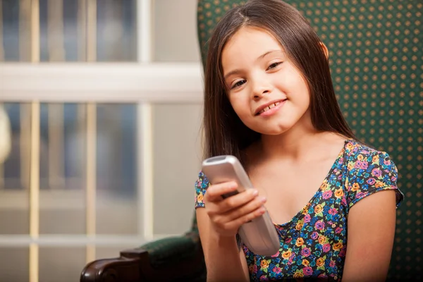 Little girl holding a remote control — Stock Photo, Image