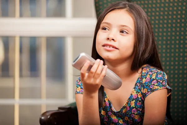Little girl holding a remote control — Stock Photo, Image
