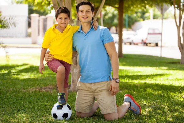 Father and his son with foot on soccer ball — Stock Photo, Image