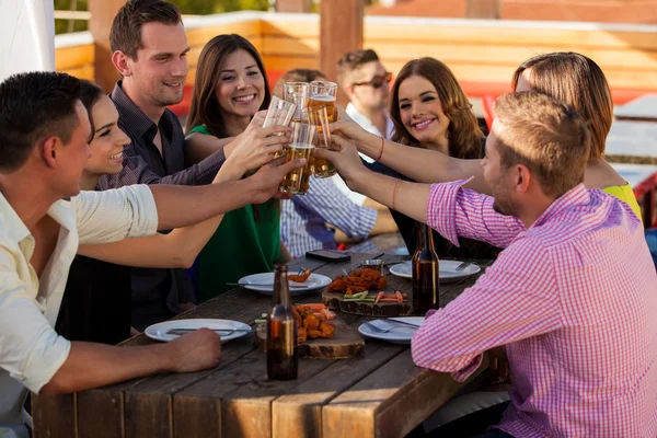 Having drinks and snacks at a bar — Stock Photo, Image