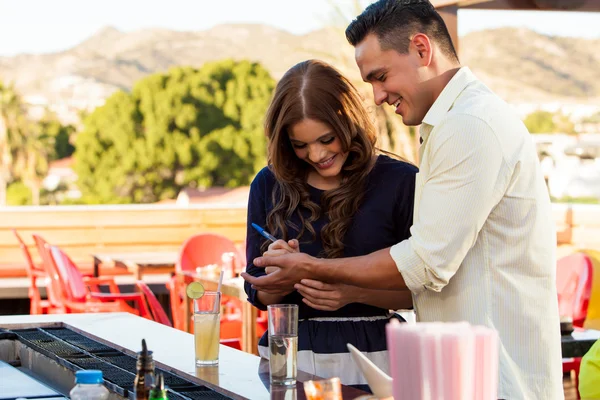 Beautiful girl flirting at a bar — Stock Photo, Image