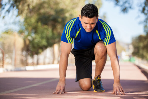 Male runner fully focused on a race