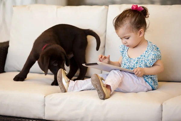 Girl with a dog and a tablet — Stock Photo, Image