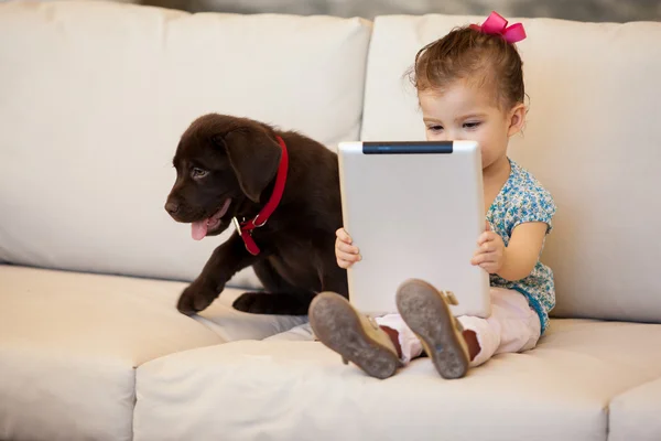 Girl with a dog and a tablet — Stock Photo, Image