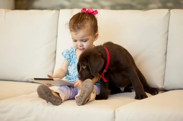 Girl with a dog and a tablet — Stock Photo, Image