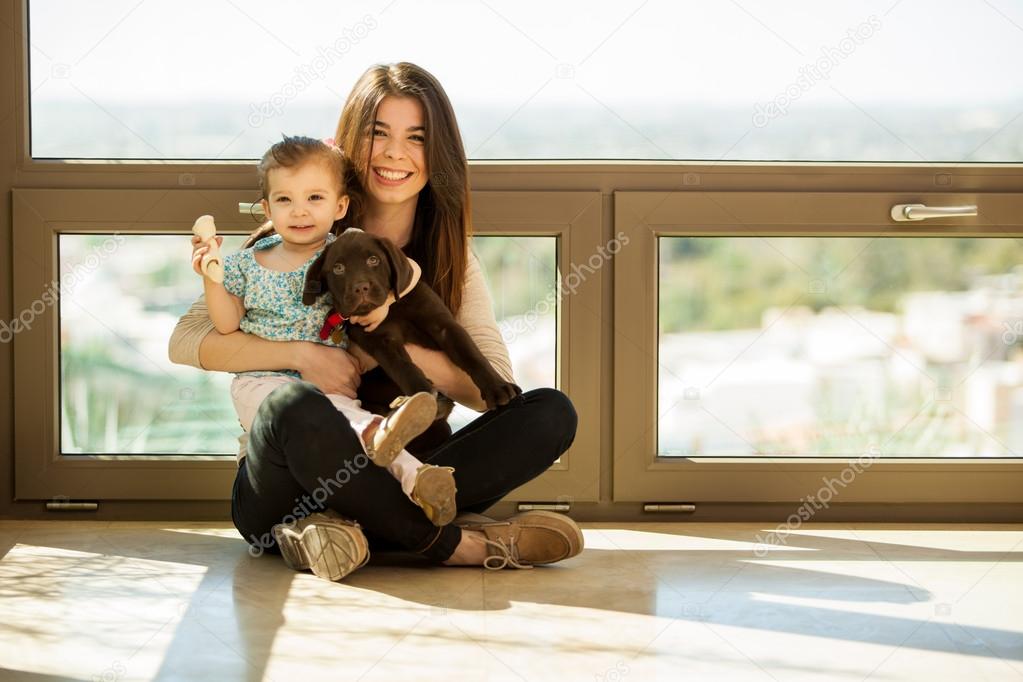 Mother and daughter playing with a dog
