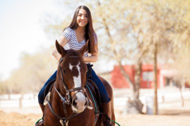 Woman enjoying a horse ride clipart