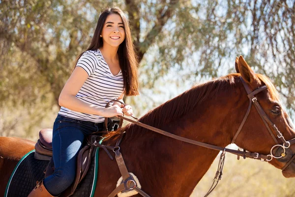 Hispanic brunette riding a horse — Stock Photo, Image