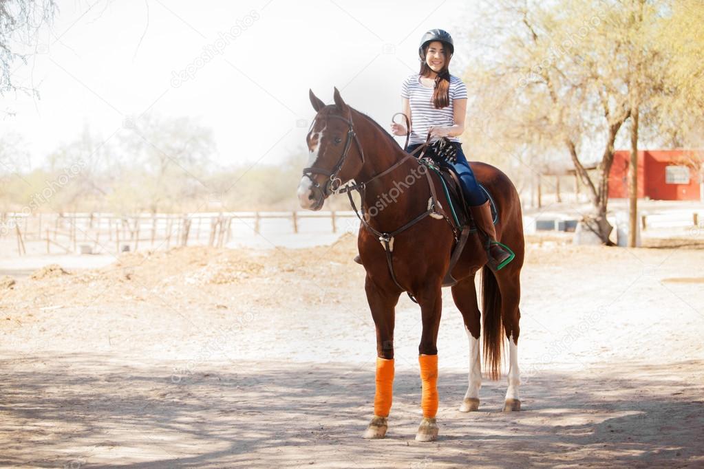 Woman in a helmet riding a horse