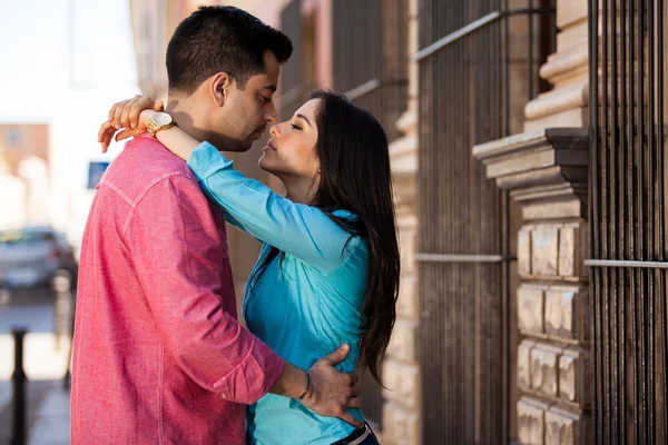 Beautiful couple hugging near the building — Stock Photo, Image