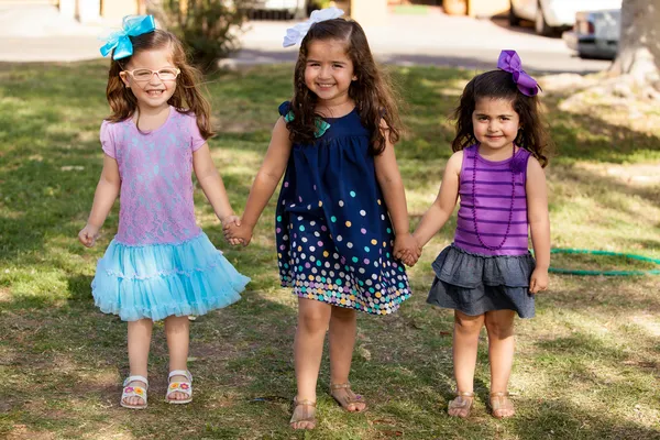 Group of little friends holding hands in a park — Stock Photo, Image