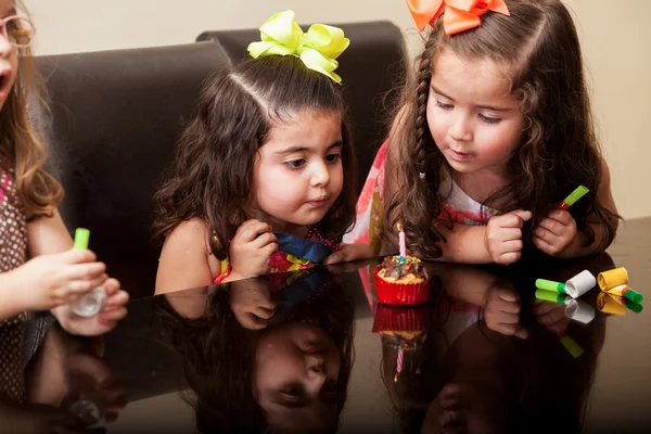 Mooi meisje en haar vrienden waait een kaars voor haar verjaardag — Stockfoto