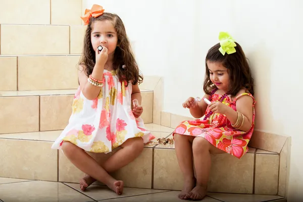 Little girls trying on some makeup at home — Stock Photo, Image