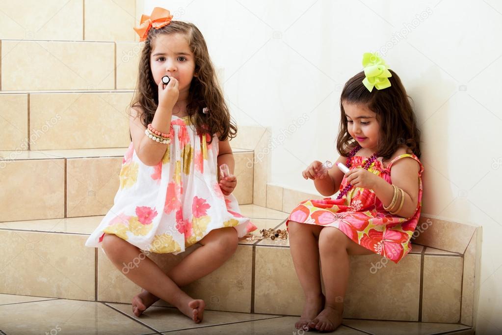 little girls trying on some makeup at home