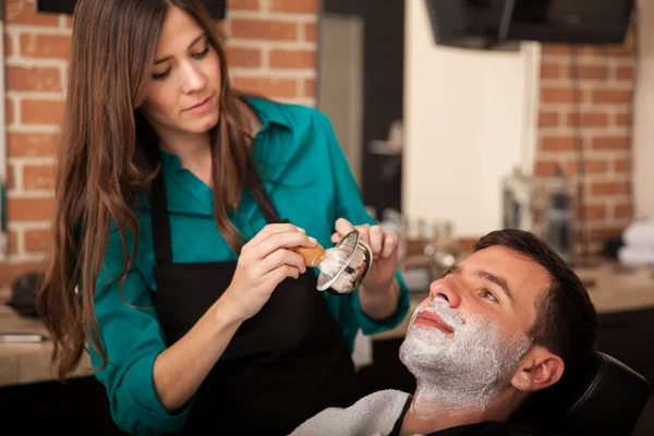 Young man getting a shave — Stock Photo, Image