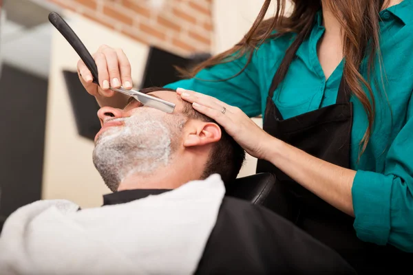 Young man getting a shave — Stock Photo, Image