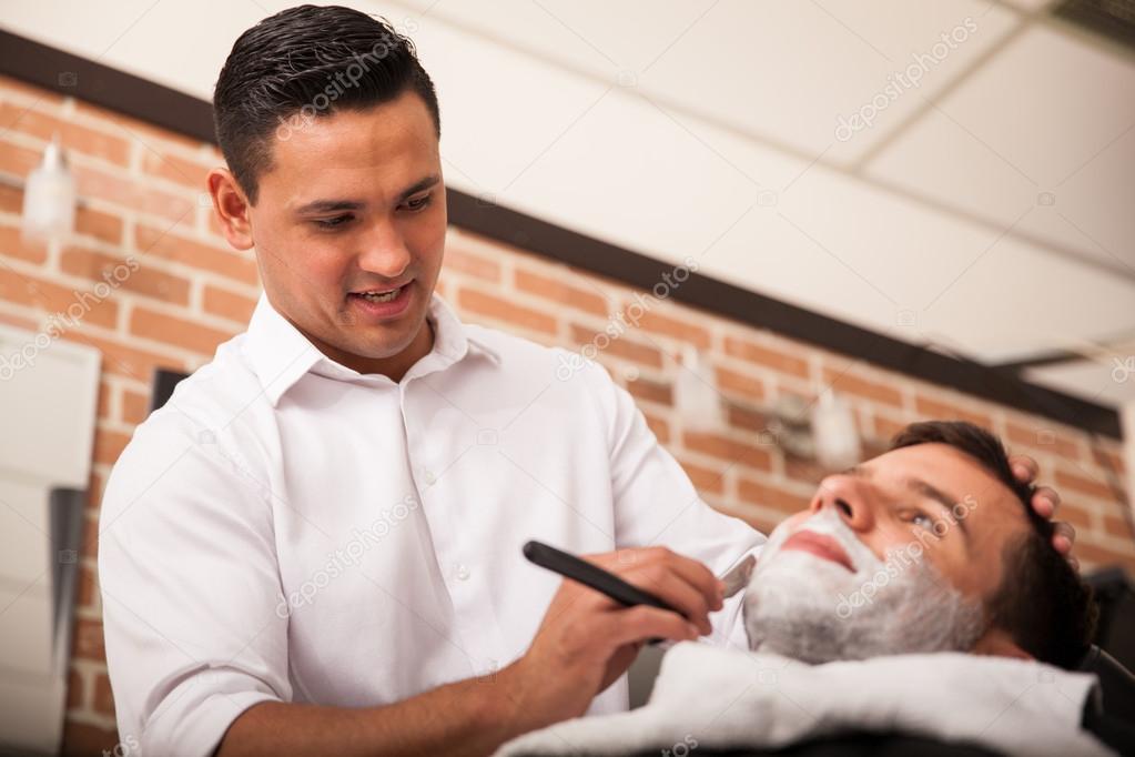 Young barber enjoying his work