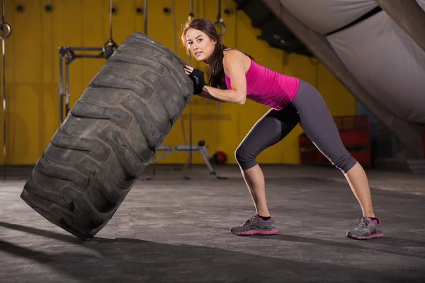 Strong girl flipping a tire