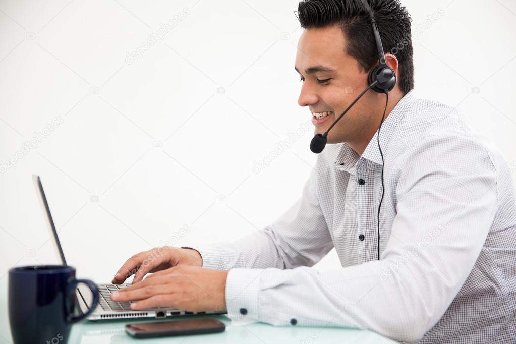 Customer service representative taking a call from a customer and smilinger