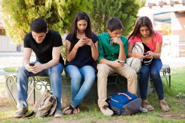 Teens busy with cell phones clipart