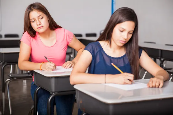 Girl cheating in a test — Stock Photo, Image