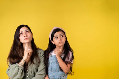 Yeni planlar düşünüyorum. Güzel Latin ailesi hayal güçlerini kullanır ve kopya alanının yanında düşünceli görünürler.