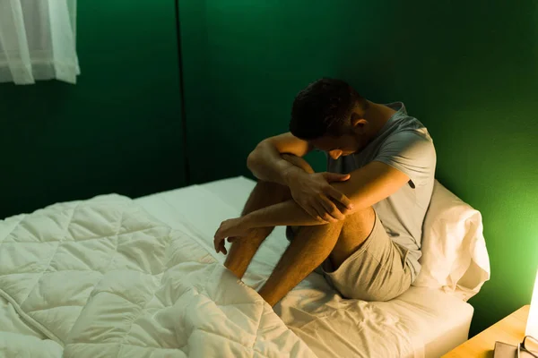 Depressieve Spaanse Man Pyjama Die Zijn Knieën Omhelst Zich Eenzaam — Stockfoto