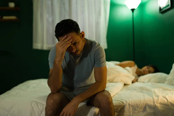 Homem Deprimido Sentado Cama Sentindo Para Baixo Enquanto Sua Namorada — Fotografia de Stock