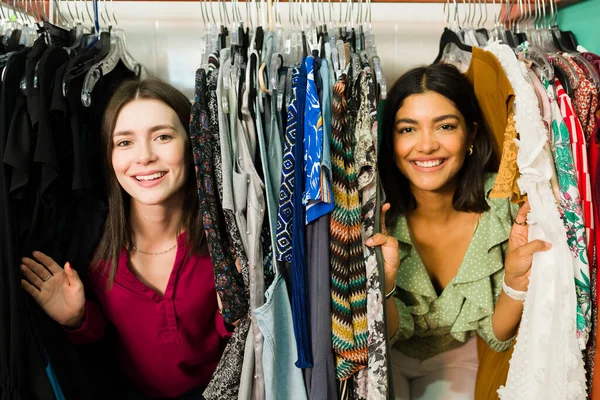 Having fun while shopping with my best friend. Young women looking for a new dress at the clothing store