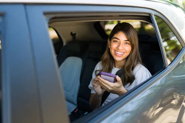 彼女の携帯電話で車を取り モバイルアプリを使用して豪華なヒスパニック系女性の肖像画 — ストック写真